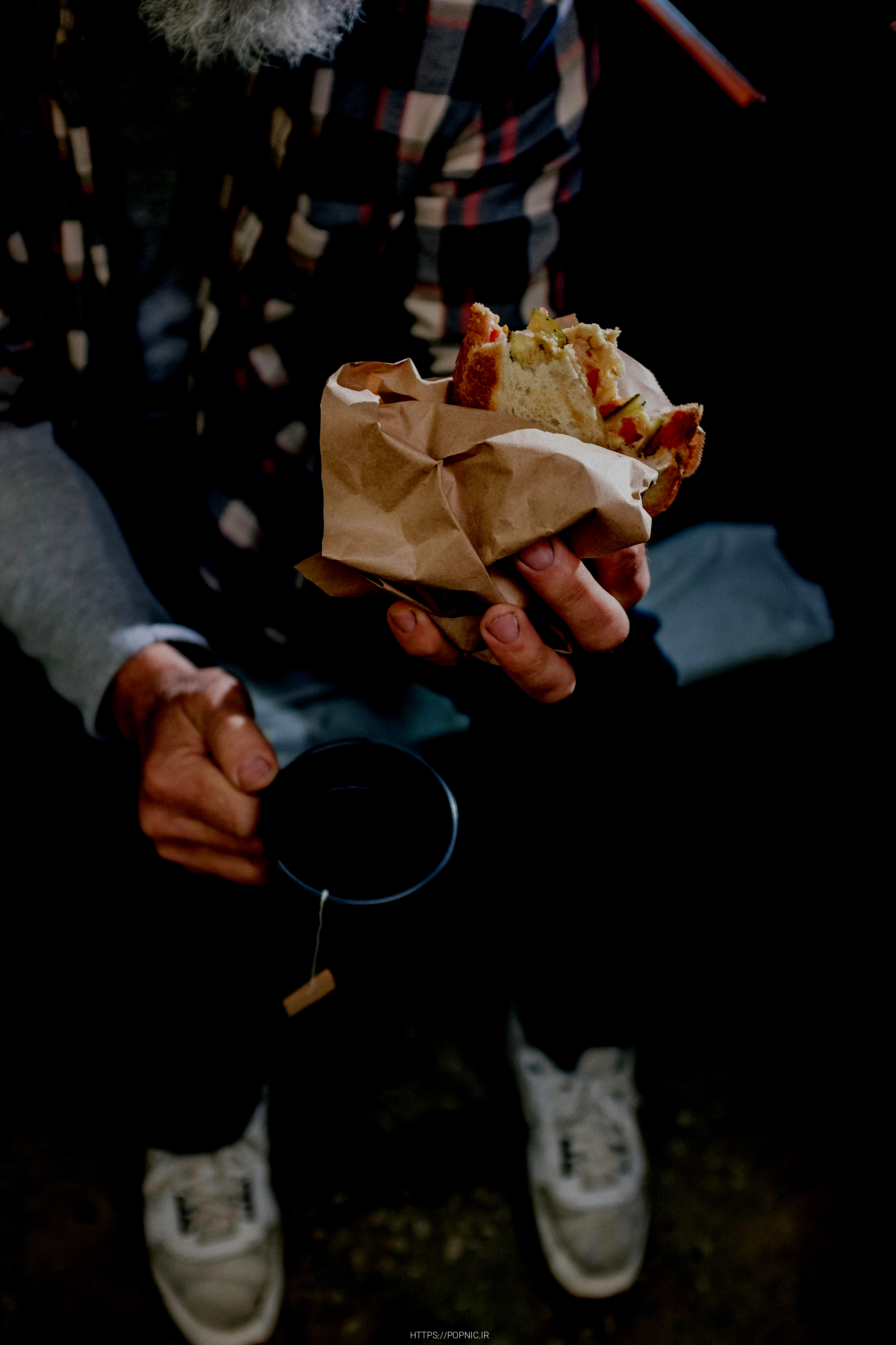 person holding a bread with white cream